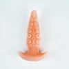 A beginner anal butt plug tail is prominently displayed against a clean white background. The plug features a smooth, tapered tip leading to a body adorned with raised circular textures for added stimulation. Its soft peach color complements the sleek design, while a wide base ensures safety and ease of use. This beginner-friendly plug is designed to enhance comfort and exploration for those new to silicone anal plugs.