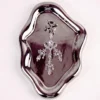 A luxurious clamp is elegantly displayed on a shiny, metallic tray. The clamp features an intricate design with silver detailing and sparkling gemstones, including a central lavender stone surrounded by shimmering accents. The clamp is styled with leaf-like embellishments that cascade down, adding a touch of glamour. This visually stunning piece combines functionality with elegance, perfect for those exploring role play dynamics.